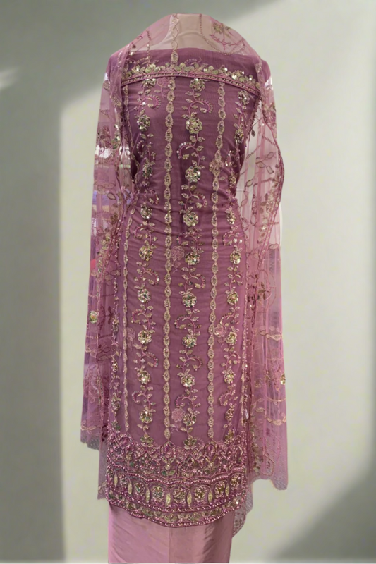 Pink embroidered traditional outfit in a store setting