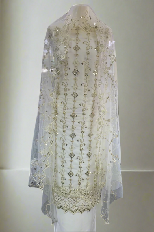 White embroidered dress on a mannequin in a store setting