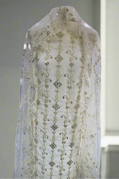 White embroidered fabric on a mannequin in a store setting