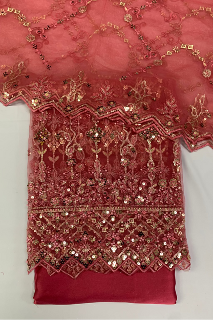 Red fabric with gold embroidery on a white background