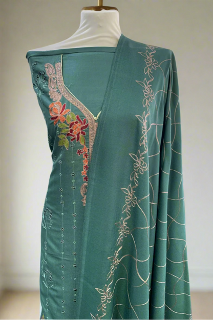 Green embroidered garment on a mannequin in a fabric store