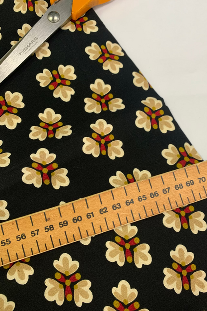 Floral-patterned fabric with a ruler for measurement on a white background