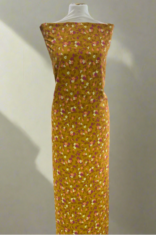 Yellow floral dress on a mannequin in a store setting.
