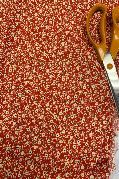 Floral fabric with a pair of scissors on top