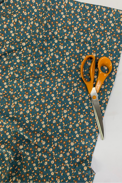 Floral fabric with a pair of scissors on a white background