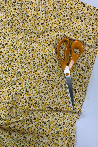 Floral fabric with a pair of scissors on a white background