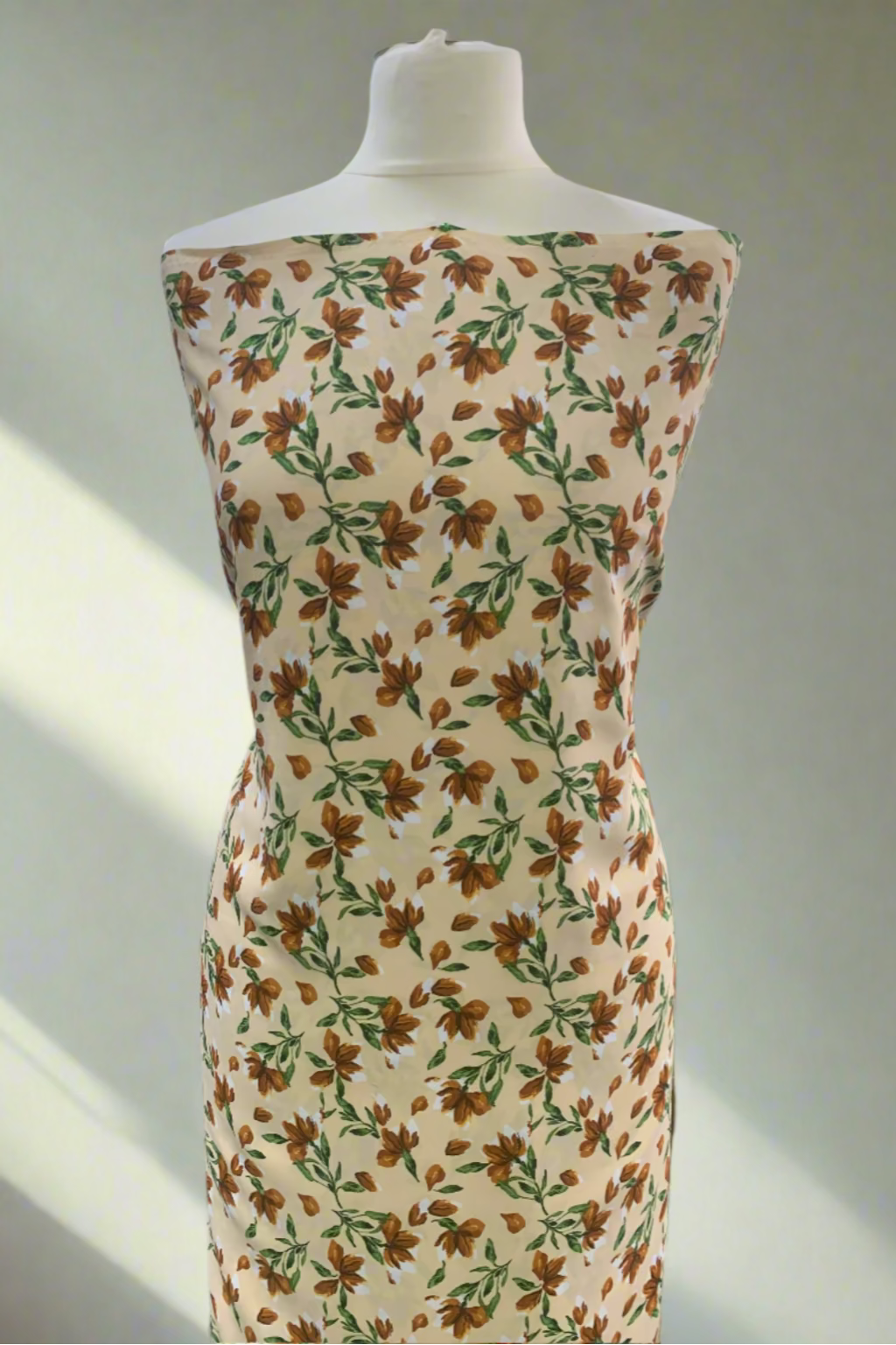 Mannequin wearing a floral dress in a store setting