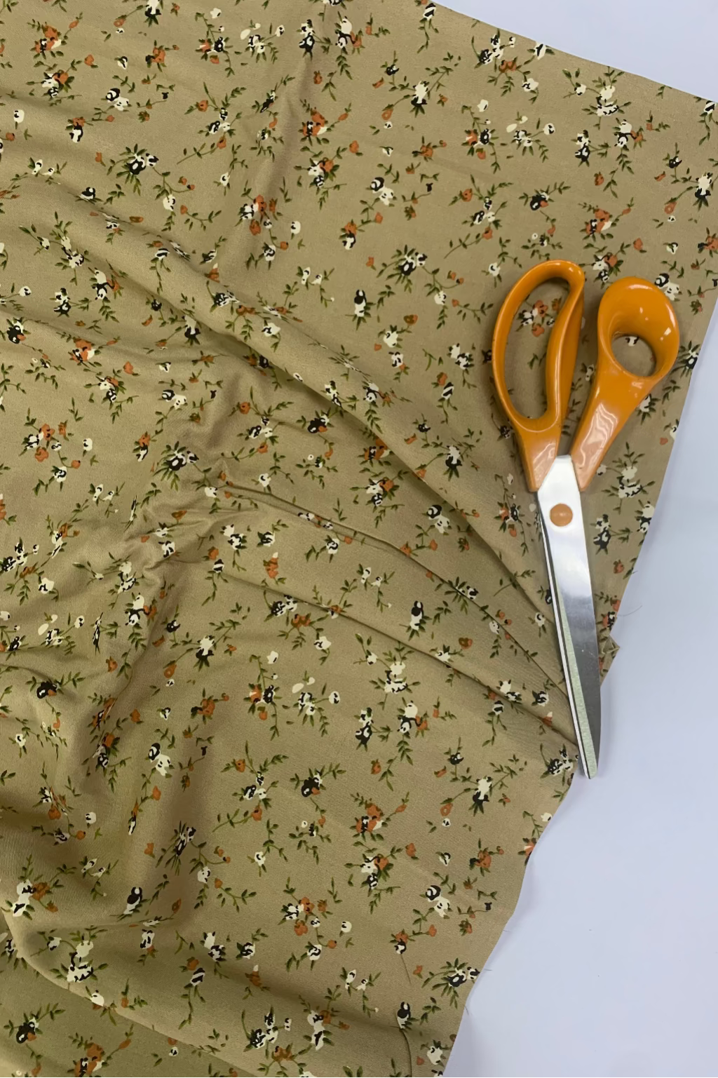 Floral fabric with a pair of scissors on top