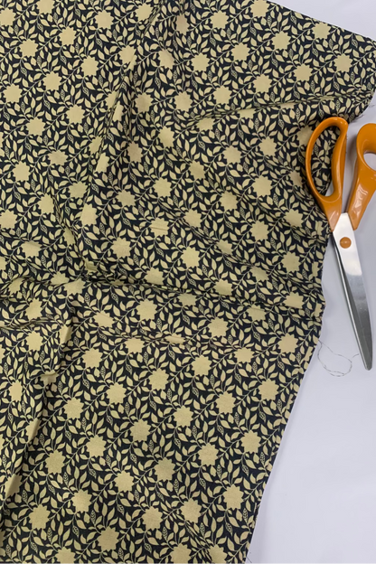 Floral-patterned fabric with scissors on a white background
