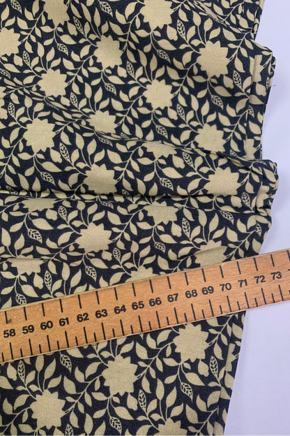Floral fabric with a ruler for scale on a white background