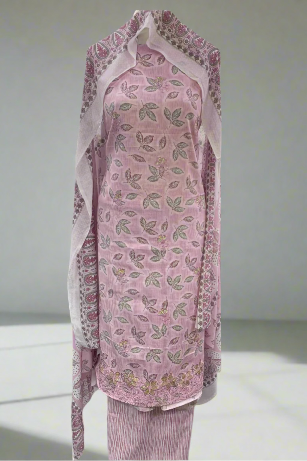 Pink floral dress on a mannequin in a store setting