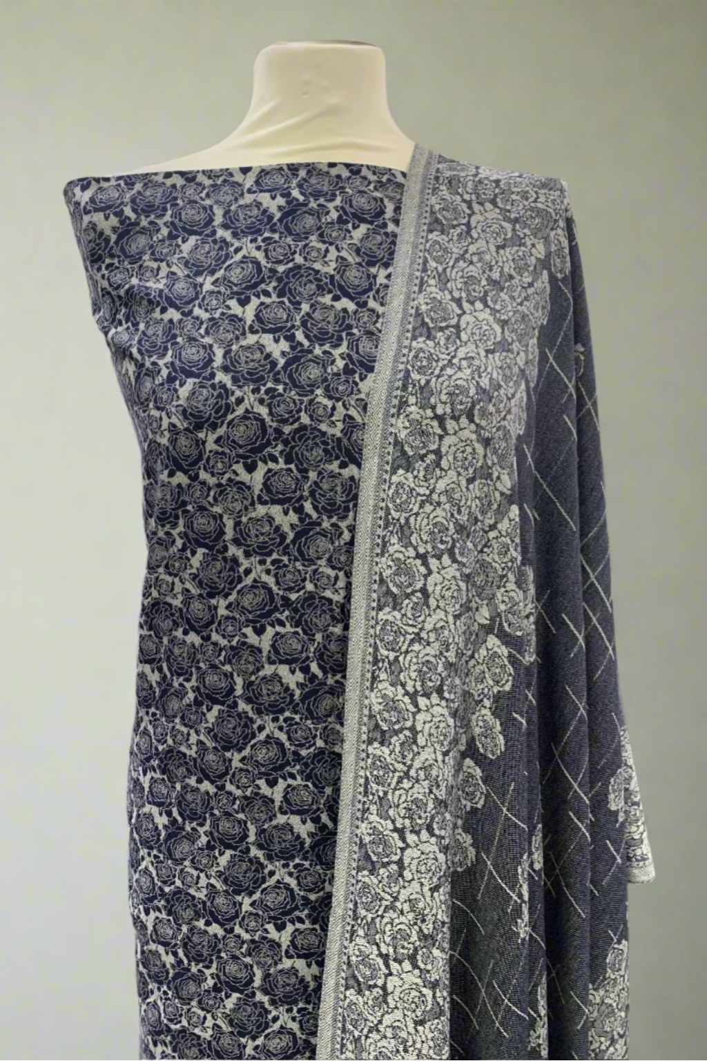 Mannequin wearing a blue and white floral fabric in a store setting