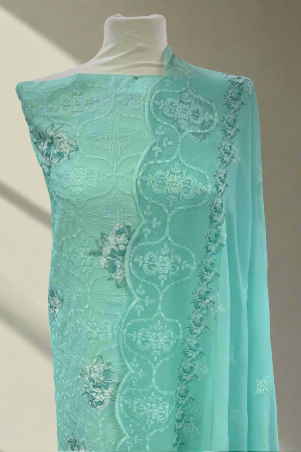 Turquoise embroidery dress on a mannequin in a store setting