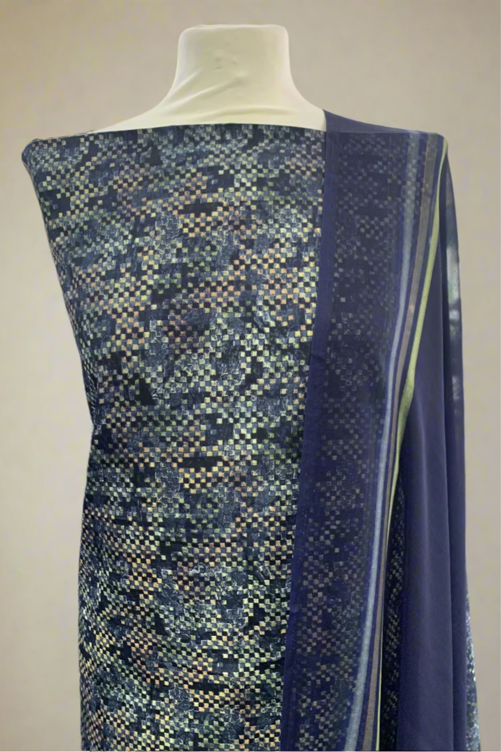 Mannequin wearing a blue patterned fabric in a fabric store.