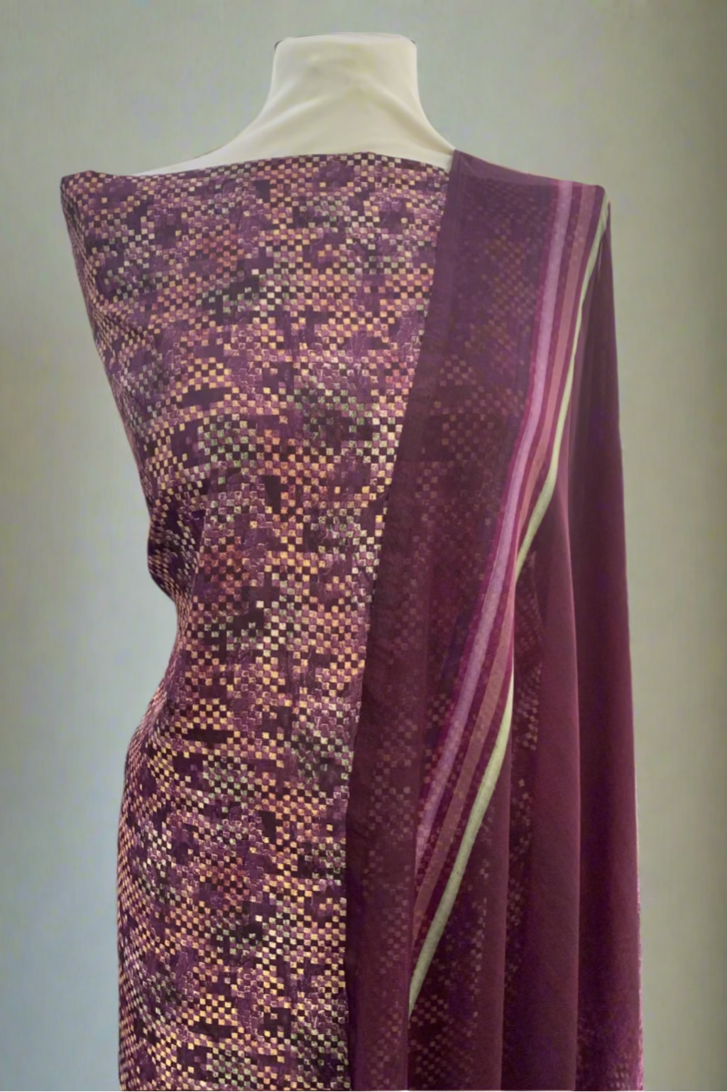 Purple fabric draped over a mannequin in a store setting