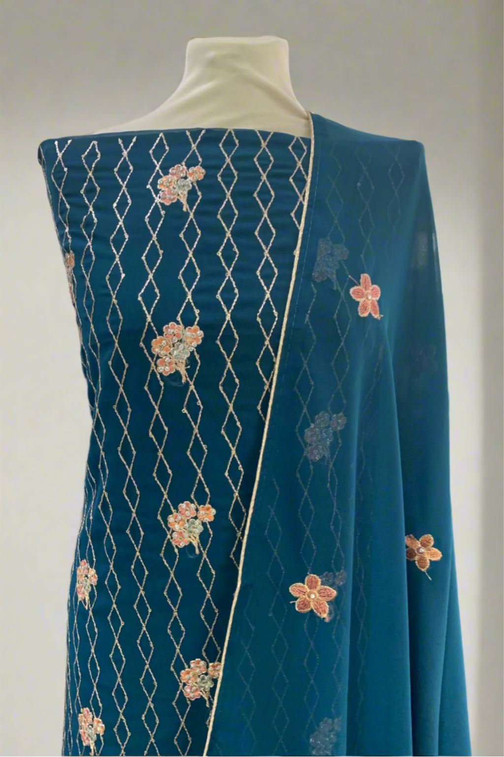 Blue fabric with floral patterns on a mannequin in a store setting