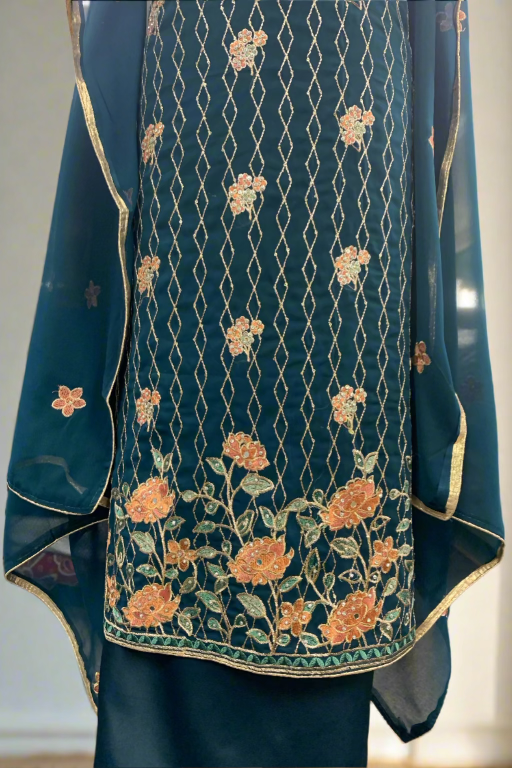 Blue embroidered garment with floral patterns in a store setting