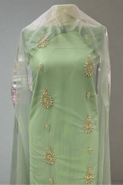 Light green embroidered dress with a sheer overlay in a store setting