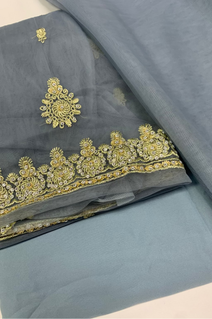 Gray fabric with gold embroidery on a white background