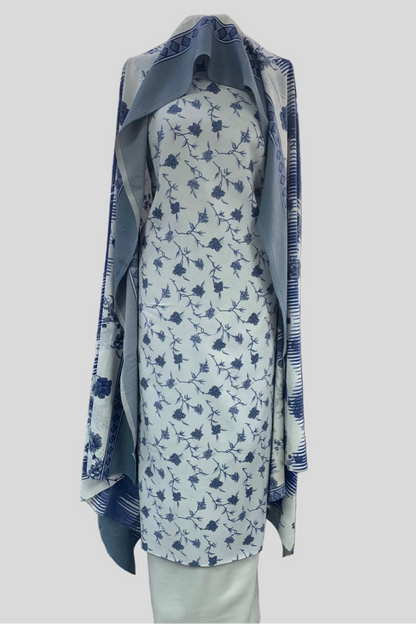 Floral dress with blue accents on a mannequin in a store setting