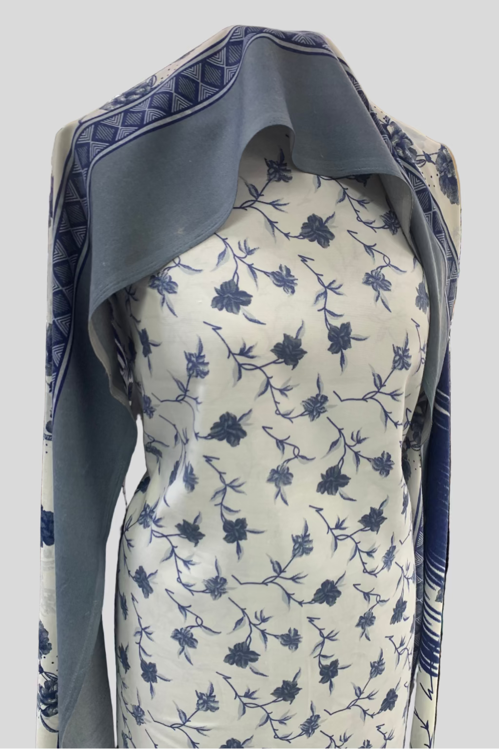 Blue and white floral patterned fabric on a mannequin in a store setting