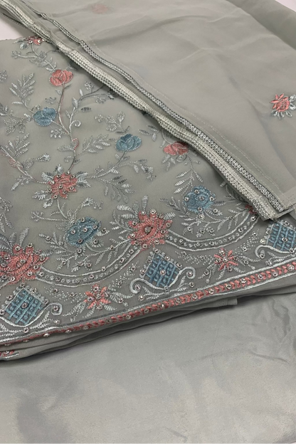 blue fabric with intricate floral embroidery on a white background