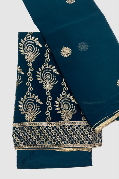 Teal blue fabric with gold embroidery on a white background