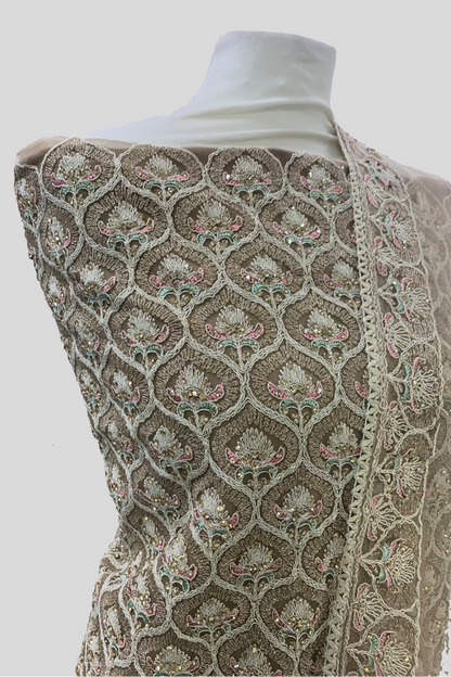 Mannequin wearing a patterned shawl with a blurred indoor background