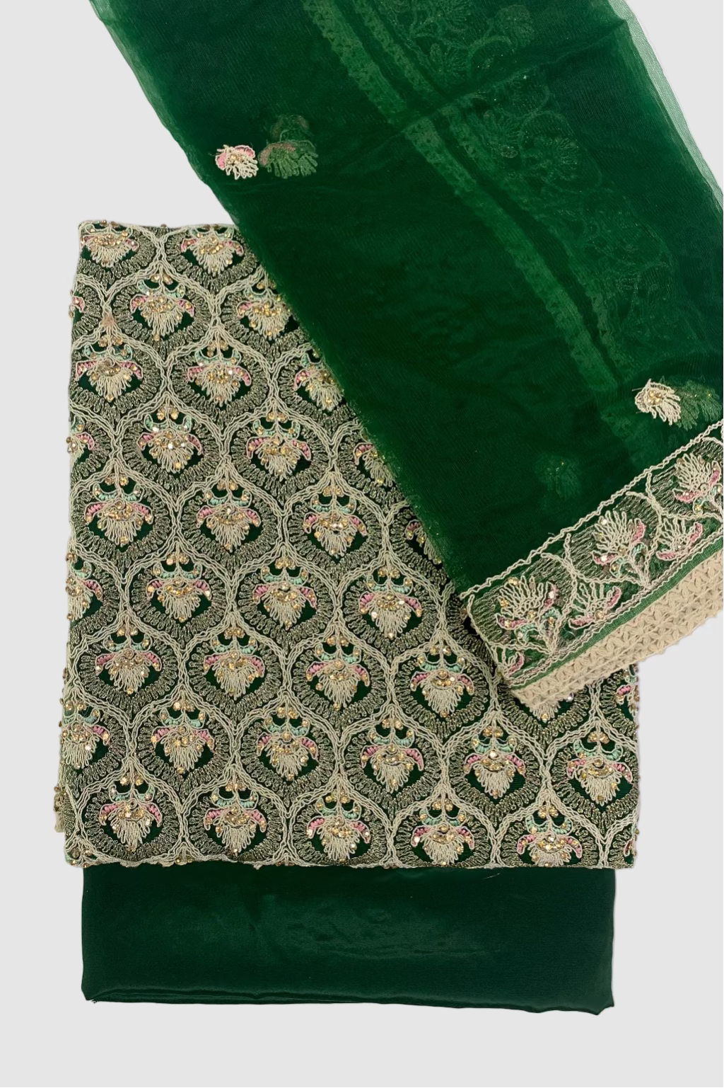 Green fabric with intricate gold embroidery on a white background