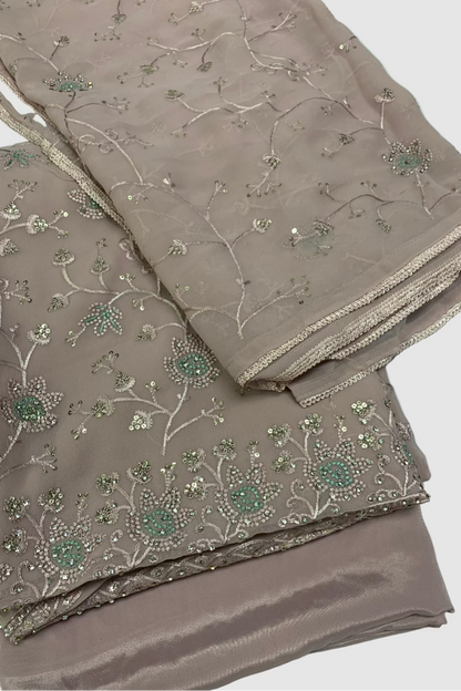 Beige fabric with floral embroidery on a light blue background