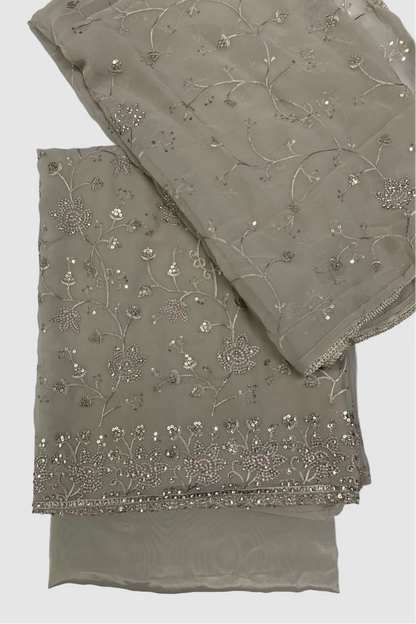 Two folded fabric pieces with floral embroidery on a white background