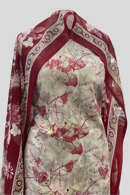 Fabric with red floral pattern on a white background, draped over a surface.
