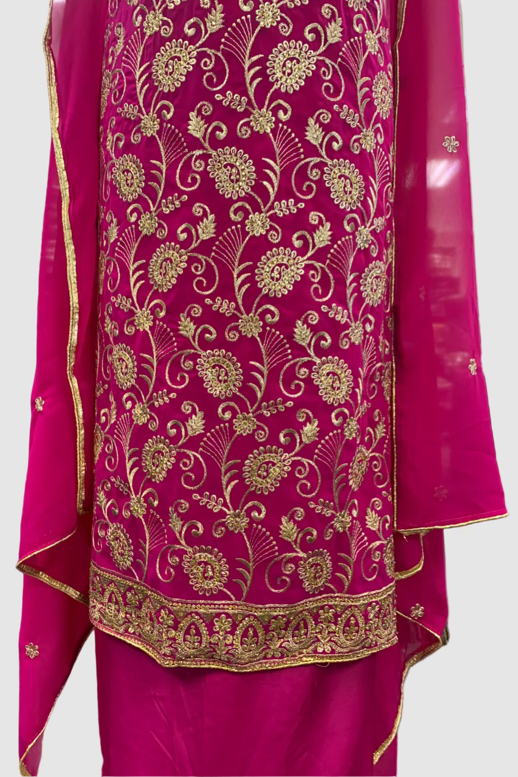 Pink dress with gold floral patterns in a store setting