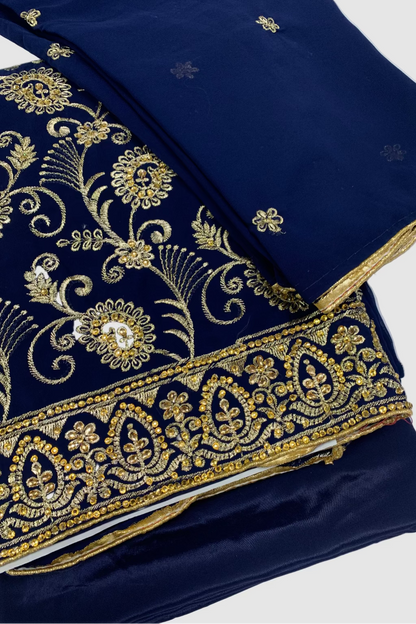 Navy blue fabric with intricate gold embroidery on a white background