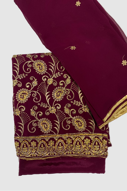 Maroon fabric with gold embroidery on a white background