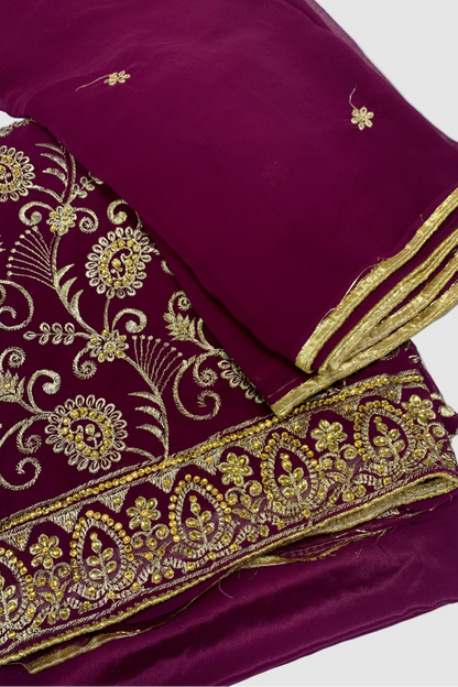 Maroon fabric with gold embroidery on a white background