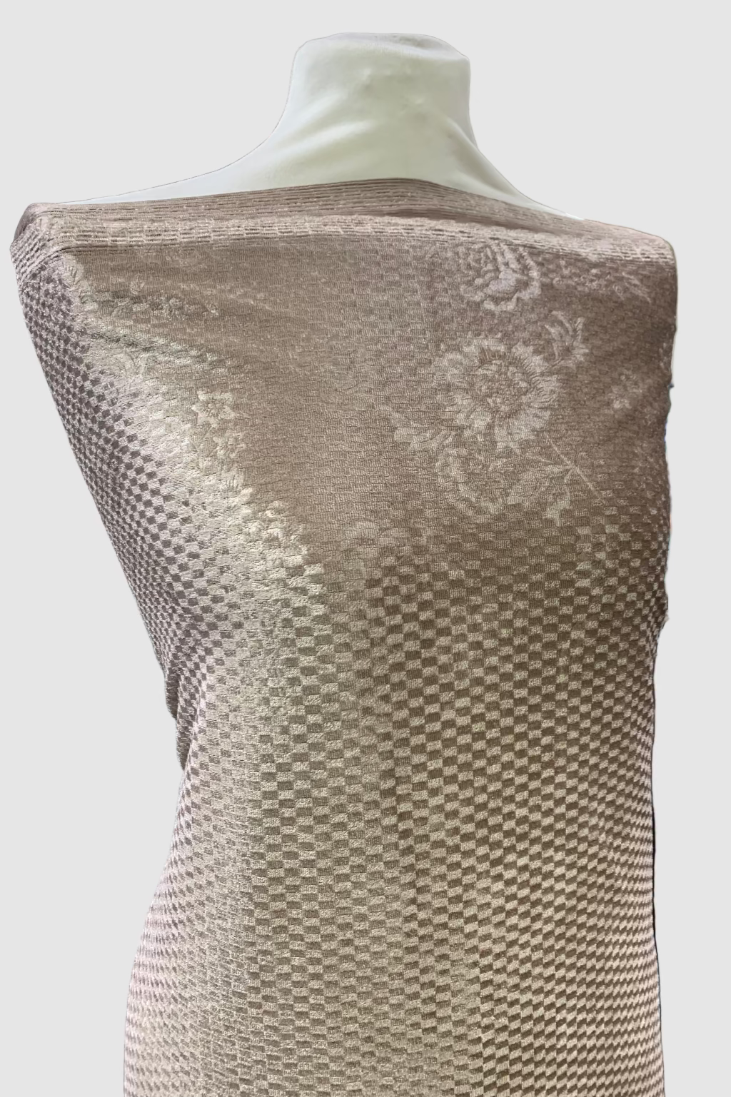 Mannequin wearing textured fabric in a store setting