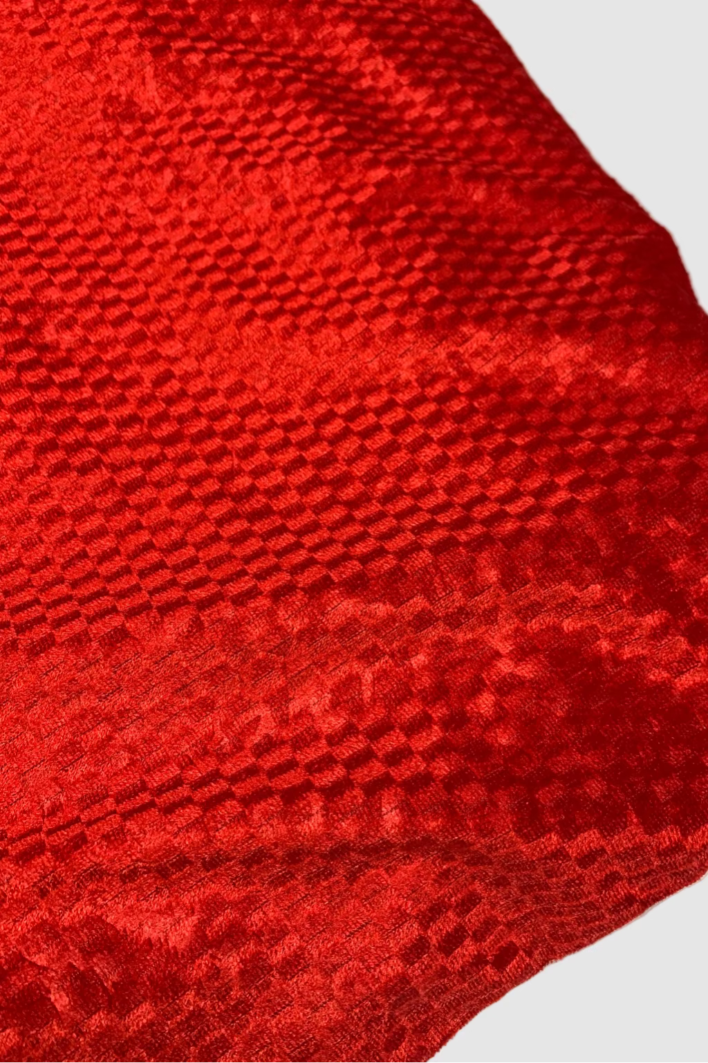 Close-up of a red textured fabric on a white background