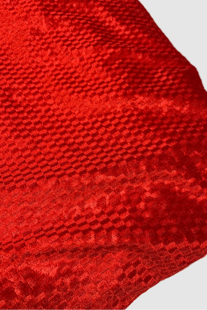 Close-up of a red textured fabric on a white background