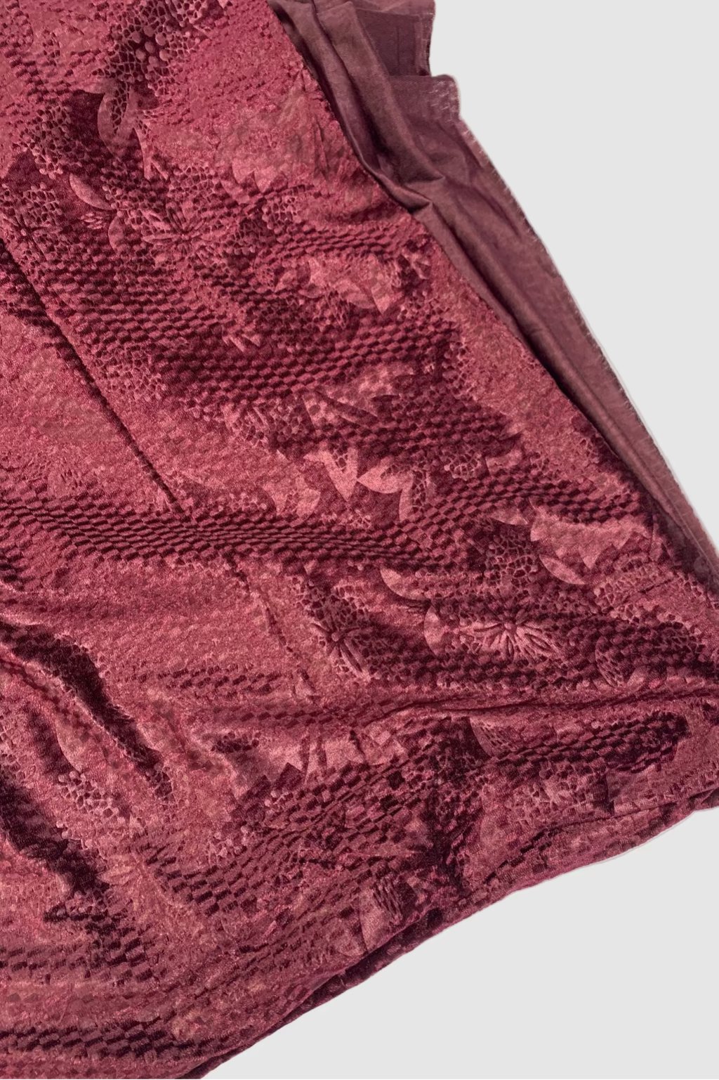 Maroon textured fabric on a white background