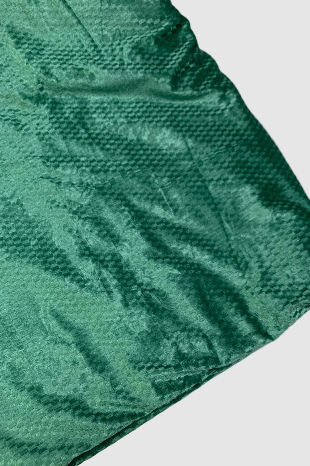 Green textured blanket on a white background