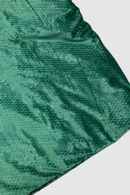 Green textured blanket on a white background