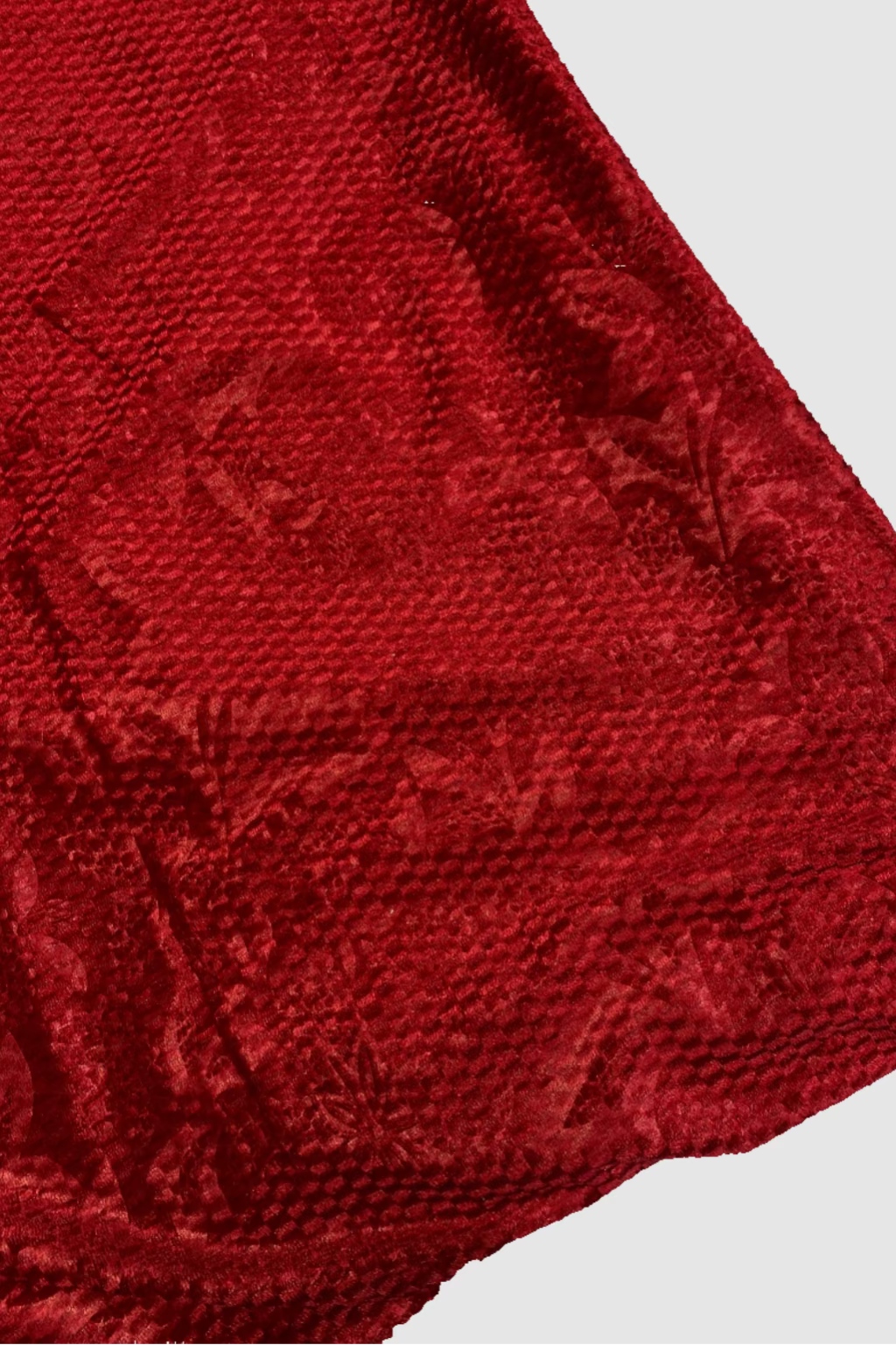 Close-up of a textured red fabric on a white background