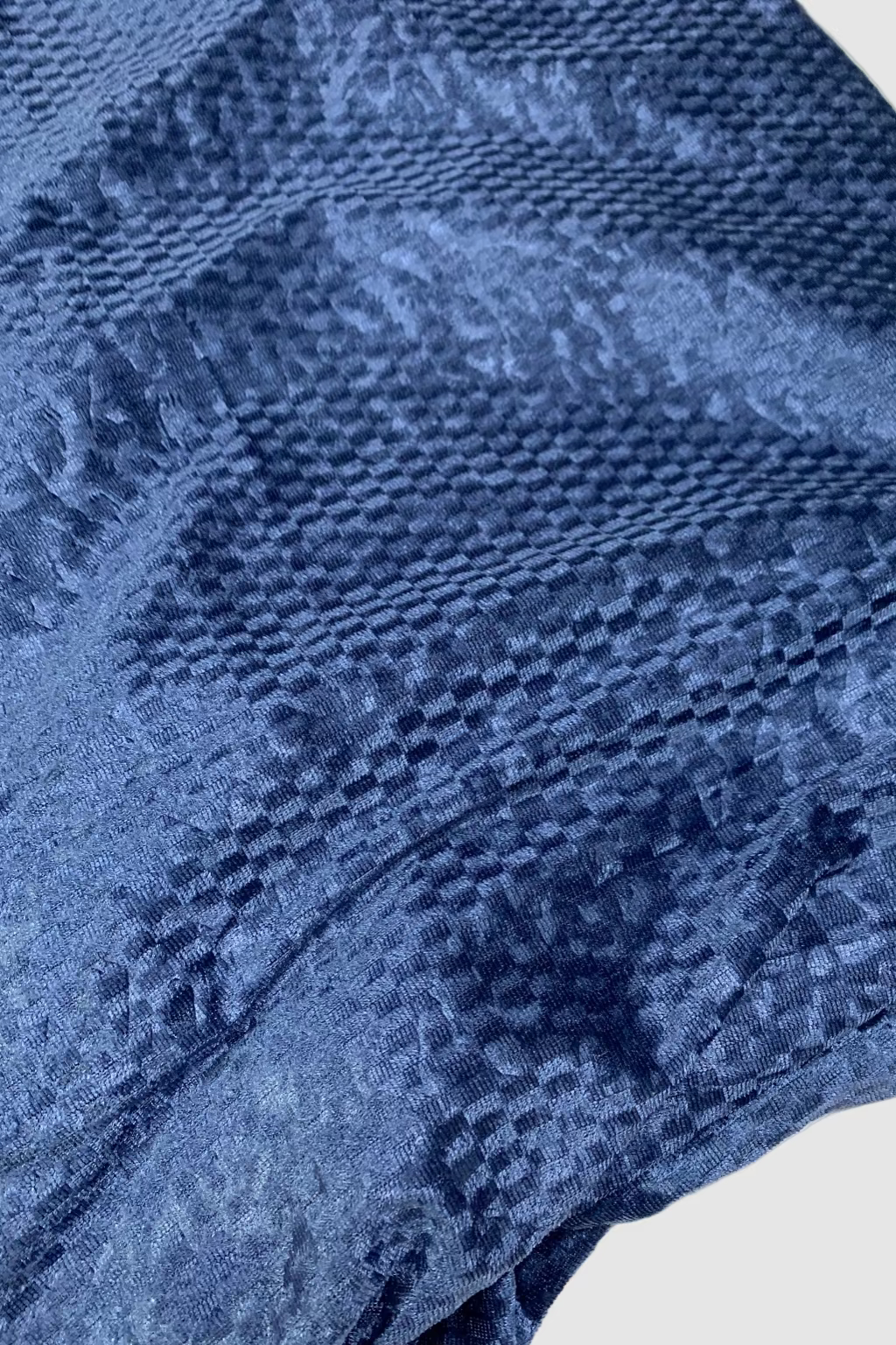 Close-up of blue textured fabric on a white background