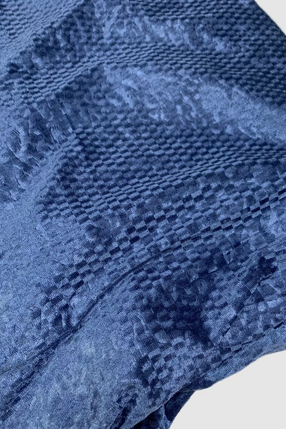 Close-up of blue textured fabric on a white background