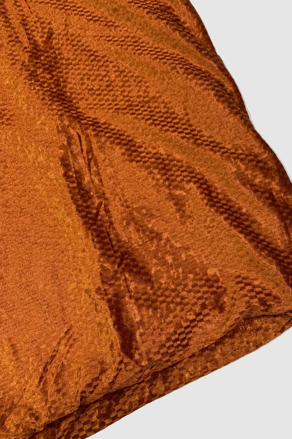 Brown textured fabric on a white background