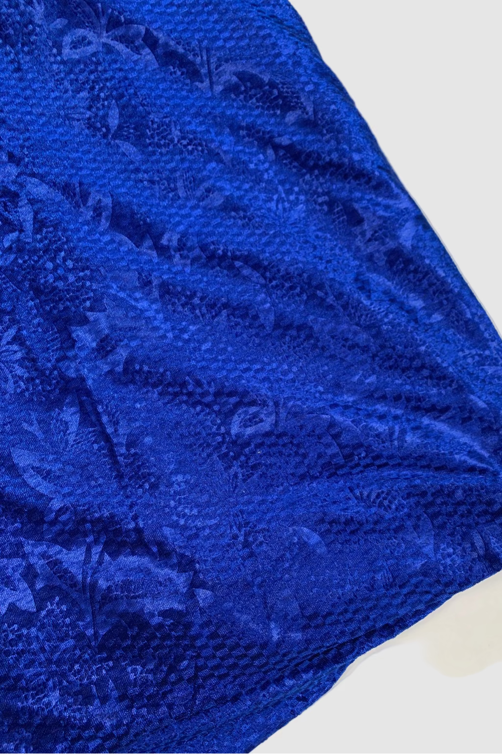 Close-up of a blue textured fabric on a white background