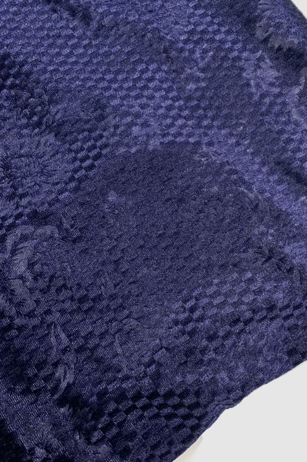 Close-up of a textured blue fabric on a white background