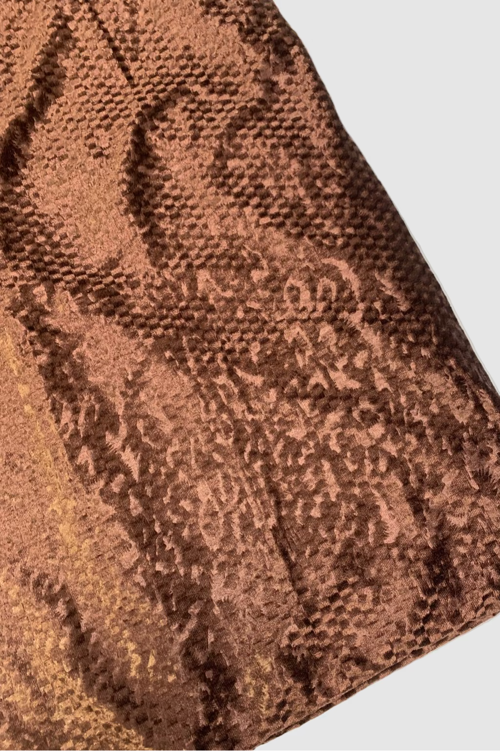 Close-up of brown textured fabric on a white background