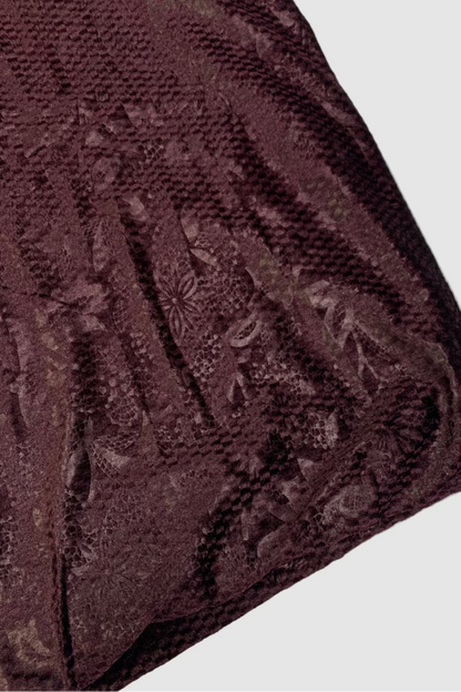 Purple textured fabric with floral patterns on a light background